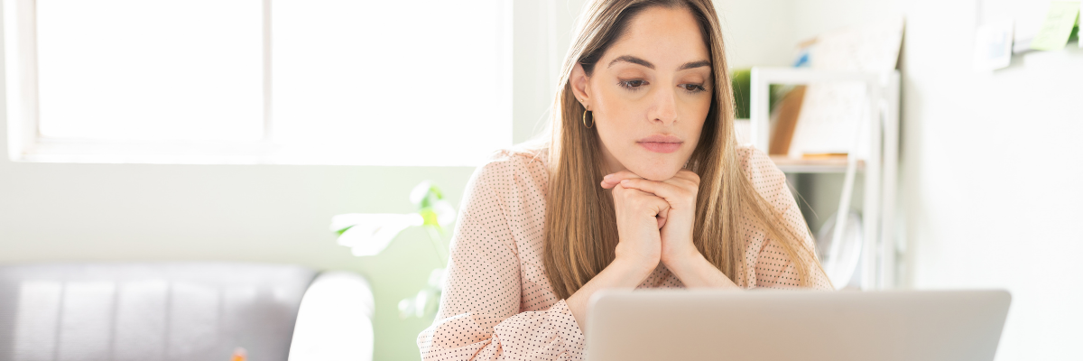 A woman looking for new clear braces on her laptop.